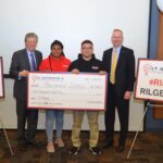 LT. GOV. Dan McKee, left, with Ron McLean, President/CEO of the Cooperative Credit Union Association, right as they present a scholarship to the first place winners of the 2019 Lt. Governor's Entrepreneurship Challenge, Providence Detailing, a pitch team consisting of Alejandro Martinez, center left, and Laila Martin, center right. / COURTESY LT. GOVERNOR'S OFFICE