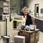 NEW ENGLAND INSTITUTE of Technology Director of Nursing and Interim Assistant Provost of Health Services Darlene Noret stands with medical supplies the school will donate Tuesday to Care New England to help with the COVID-19 pandemic. / COURTESY NEW ENGLAND INSTITUTE OF TECHNOLOGY