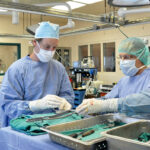 TECH IN USE: John Jarrell, left, president of Materials Science Associates, and Dr. Christopher Born, director of orthopedic trauma at Rhode Island Hospital, work to apply a patented anti-microbial technology in a surgical procedure to reduce infection of medical implants. ­Jarrell has increased his company’s investment in patent filings and other intellectual property activity to respond to ­COVID-19. / COURTESY MATERIALS SCIENCE ASSOCIATES LLC