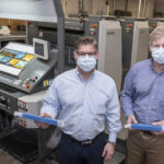 DIVERSIFIED: Kevin Sheahan, left, and David Sheahan are the owners of Sheahan Printing in Woonsocket, a multigenerational, family-owned printing company that has transitioned to making face shields. / PBN PHOTO/MICHAEL SALERNO