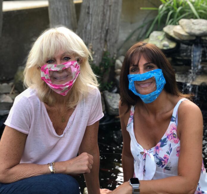 LOCAL TEACHERS Linda Harnois, left, and Linda Greco have created face masks with clear covering to allow faces to remain visible while wearing them. / COURTESY LINDA GRECO