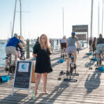 HOME FOCUS: Ella Gonzalez, Newport Harbor Hotel and Marina director of sales and marketing, stands on a pier where the hotel is hosting a fitness studio’s cycling classes. / PBN FILE PHOTO/TRACY JENKINS