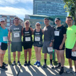 RUNNING WILD: CBIZ Inc. employees, from left, Claudia Mullen, managing director; Justin Beaulieu, associate; Suzanne Jalbert, director; Liz Kozar, manager; Derek Antone, senior associate; Leo Drury, senior manager; and Kenny Boucher, manager, pose while participating in a recent IGT Downtown 5K in Providence.  / COURTESY CBIZ INC.