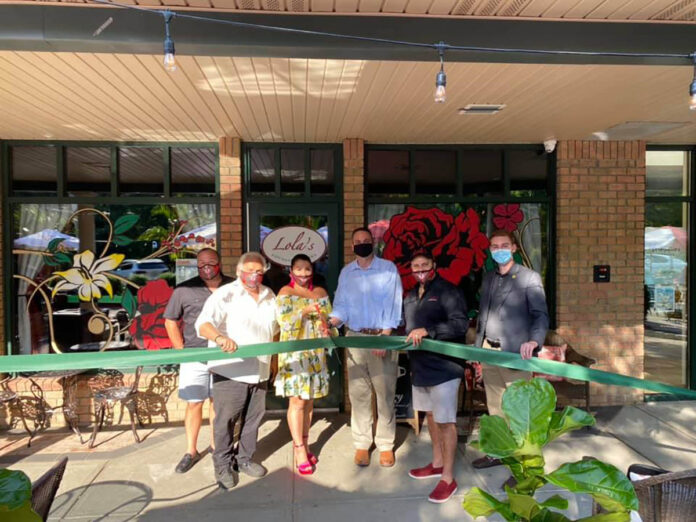 OPENING ACTION: Jodi Ricci, third from the left, and her husband, Michael Mota, fourth from the left, cut the ribbon at the opening of Lola’s Lounge and Cantina in Smithfield. Joining them, from left, are Scott Connory, vice president of sales; Joe Ricci, co-owner; Smithfield Town Manager Randy Rossi; and Town Councilman Sean Kilduff. / COURTESY LOLA’S LOUNGE AND CANTINA