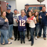 FOOTBALL FEVER: Secure Future Tech Solutions employees wear New England Patriots attire as part of a recent Patriots Spirit Day at the office.  COURTESY SECURE FUTURE TECH SOLUTIONS