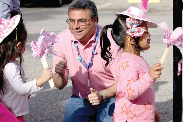 TIME TO CELEBRATE: Children’s Friend CEO and President David Caprio celebrates with students at a community event. / COURTESY CHILDREN’S FRIEND