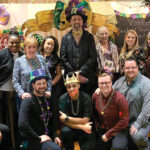 PICTURE PERFECT: Tockwotton on the Waterfront employees pose during a recent company Mardi Gras office party. COURTESY TOCKWOTTON ON THE WATERFRONT