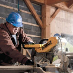 FRESH CUT: Pariseault Builders Dan Menard works on a table saw during a company project. / COURTESY PARISEAULT BROTHERS