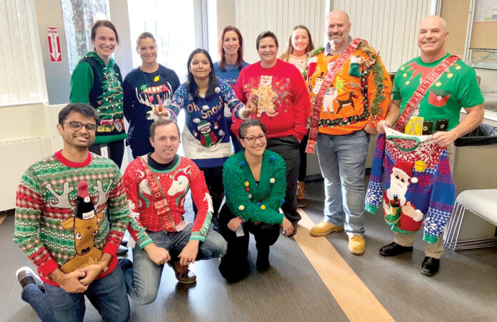 BEST-DRESSED: Rubius Therapeutics employees participate in a “Best Sweater” contest it held on behalf of the activities team in late 2019. It was accompanied by a “Giving Tree” for local families in need. / COURTESY RUBIUS THERAPEUTICS