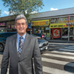 LATINO ADVOCATE: Oscar Mejias, CEO of the Rhode Island Hispanic Chamber of Commerce, stands along Westminster Street in the Olneyville section of Providence that features an enclave of Latino-owned businesses.  / PBN PHOTO/MICHAEL SALERNO