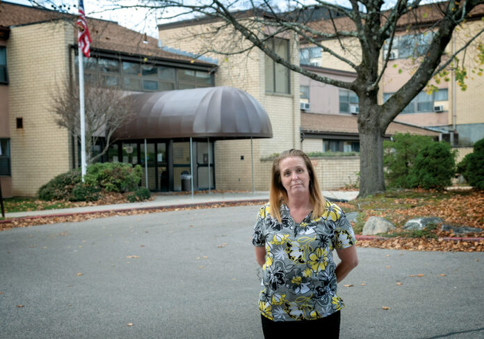 ON DUTY: Dawn Auclair, a certified nursing assistant at Hopkins Manor in North Providence, says her family asks her not to go work because of the dangers surrounding COVID-19, but she’s passionate about her job and the residents who live there.  / PBN PHOTO/MICHAEL SALERNO