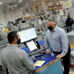BY THE NUMBERS: Hexagon Manufacturing Intelligence-Metrology Software Inc. Vice President of Operations Steven Ilmrud, right, says a new automated system has helped the North Kingstown company improve efficiency and accuracy. Ilmrud is pictured with Production Manager Ted Coppa. / PBN FILE PHOTO/ELIZABETH GRAHAM
