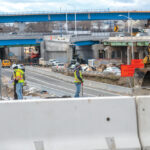 UP-ROUTED: Construction workers are on-site at the Westminster Street overpass, part of the Route 6-10 connector project in Providence. Visible in the background is the “flyover” bridge, a major feature of the new design for the busy exchange.  / PBN PHOTO/MICHAEL SALERNO