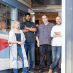 A FRESH TAKE: PB Bistro & Bar in East Greenwich is offering family-sized vegan and vegetarian dishes for the holidays. Patti Burton, far left, and Dan Hatch, far right, opened the plant-based eatery in the spring. With them are sous chef O’Laro Waite, second from the left, and executive chef Mike Fleury.  / COURTESY CAITLIN COSTA