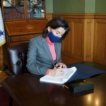 GOV. GINA M. RAIMONDO signs the fiscal 2021 state budget on Monday. / COURTESY R.I. GOVERNOR'S OFFICE
