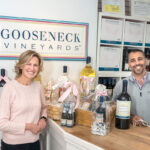 SCOURING THE GLOBE: Cousins Liana Buonanno and Paul Fede, co-owners of Gooseneck Vineyards, work with farmers in six countries to source the grapes for their classic, budget-friendly wines, which they sell in their North Kingstown vineyard shop.  PBN PHOTO/MICHAEL SALERNO