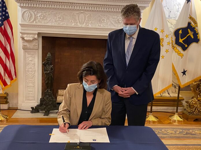 GOV. GINA M. RAIMONDO signs an executive order on Monday authorizing Lt. Gov. Daniel J. McKee to oversee and manage the fiscal year 2022 state budget. / COURTESY R.I. OFFICE OF THE GOVERNOR