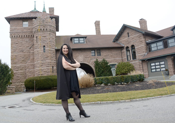 PLANNING AHEAD: While large weddings being planned by Angelic Affairs LLC are still scheduled for this summer and fall in Newport, owner Kelly Teves, pictured in front of the OceanCliff Hotel in the city, says three of her clients that had originally booked dates in 2020 have moved them to 2022 and she’s already getting inquiries about 2023. / PBN PHOTO/ELIZABETH GRAHAM