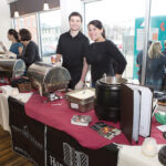 DISHING IT OUT: Ciro’s Tavern in Woonsocket has participated in The Poutine Indulgence tasting competition in the past. Noah Peloquin, left, and Gina Savini, Ciro Tavern owner, work at the serving station during the 2018 competition at the Museum of Work and Culture in Woonsocket. / COURTESY JUDITH POTTER 