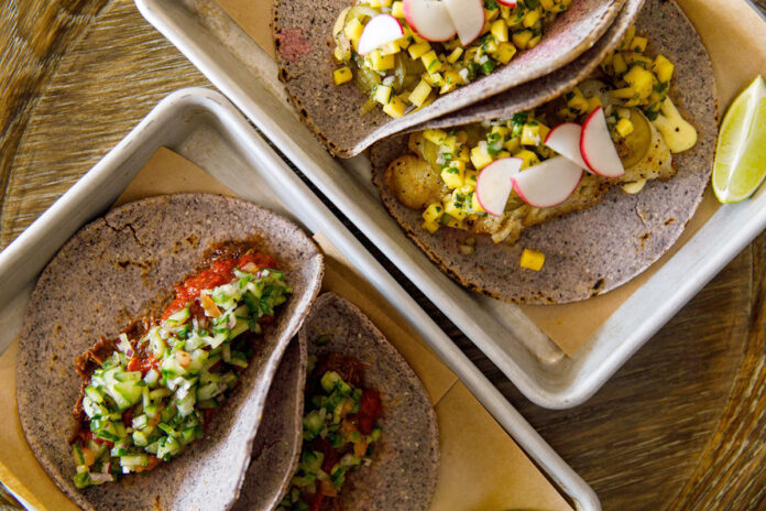 TAKE IT AWAY: Pan-seared redfish tacos, right, and short rib tacos are available through a “ghost kitchen” called La Vecina in Newport, which offers Mexican street food by takeout or delivery only. / COURTESY ERIN MCGINN