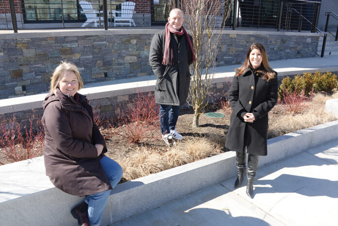 GROWTH SECTOR: From left, Kris Bradner, Arthur Eddy and Ashley Iannuccilli Cullion, principals with Traverse Landscape Architects LLC, at the Hammetts Hotel in Newport. The company, which recently completed the landscape planning for the hotel, has seen its portion of business related to the hospitality sector increase dramatically in the past several years. PBN PHOTO/ELIZABETH GRAHAM 