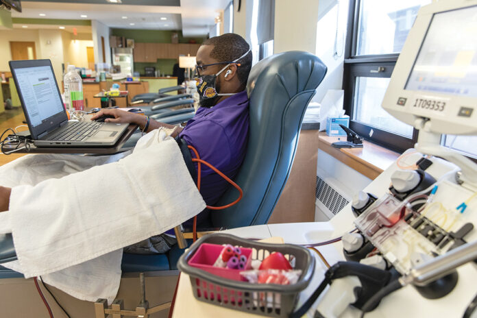 IN NEED: Andre Gill donates blood at the Rhode Island Blood Center. The center says donations are decreasing as people become more active as the economy reopens and COVID-19 infections decline. / PBN PHOTO/RUPERT WHITELEY