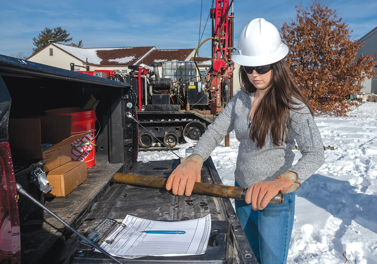 HANDS-ON: Stephanie Robat, owner of FR Engineering Group Inc., prepares to examine a core sample brought up by a drill rig on a work site in Warwick. / PBN FILE PHOTO/MICHAEL SALERNO