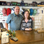AT THEIR POST: John and Sarah Cullen behind the counter of their gift shop Solstice on Water Street on Block Island. They’re hoping for a very busy summer. / PBN PHOTO/CASSIUS SHUMAN