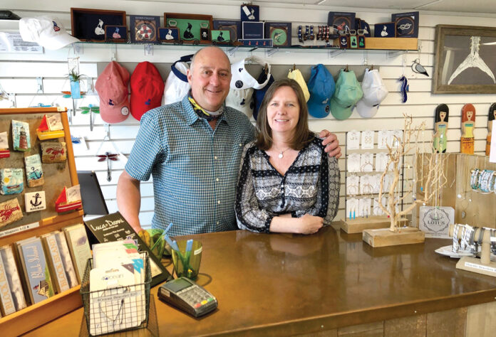 AT THEIR POST: John and Sarah Cullen behind the counter of their gift shop Solstice on Water Street on Block Island. They’re hoping for a very busy summer. / PBN PHOTO/CASSIUS SHUMAN