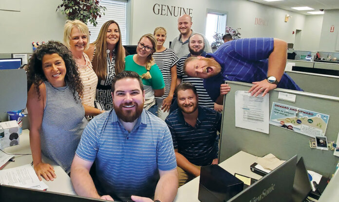 EARNING THEIR STRIPES: Employees at Vertikal6 participate in a ­recent Stripe Shirt Day at the office. / COURTESY VERTIKAL6
