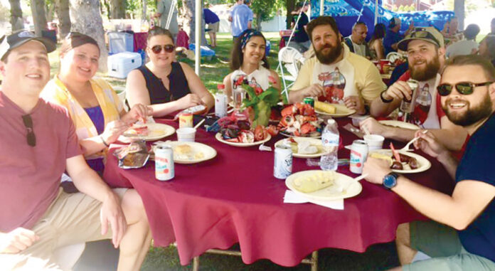 DELICIOUS DAY: AVTECH Software Inc. employees enjoy a meal during a company outing. / COURTESY AVTECH SOFTWARE INC.