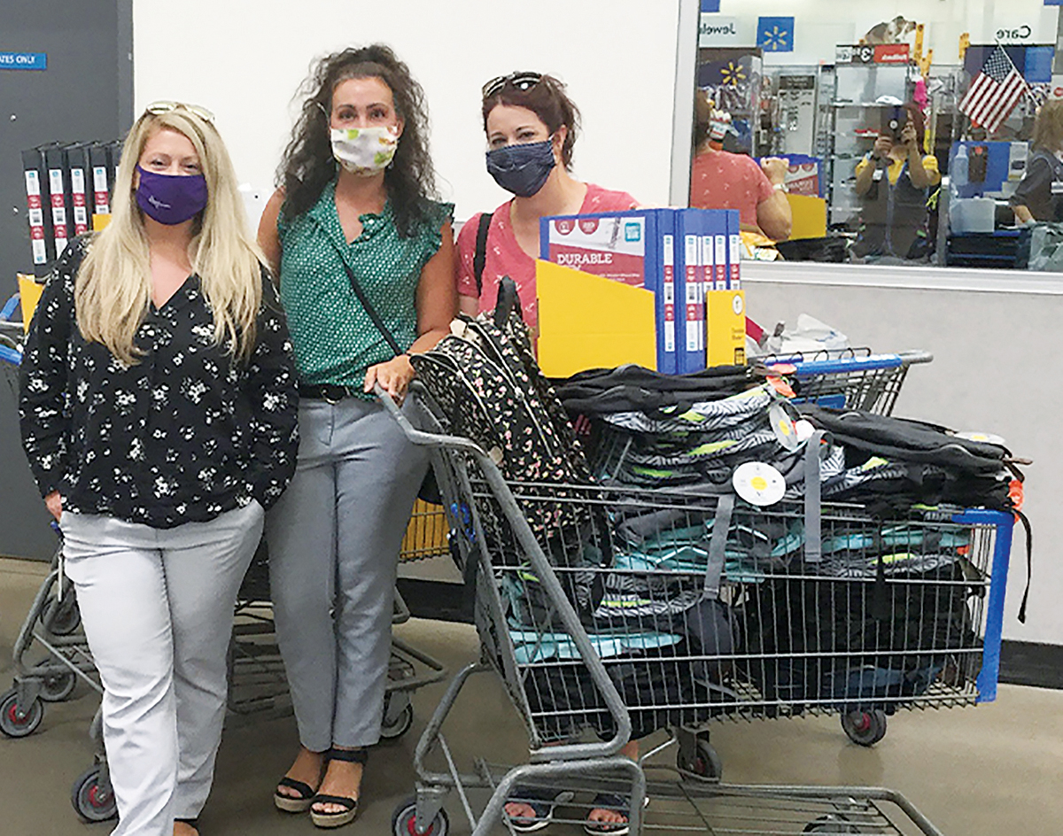 OUT SHOPPING: Navigant Credit Union employees went shopping for backpacks and school supplies, which were provided to the families of The Izzy Foundation. / COURTESY NAVIGANT CREDIT UNION