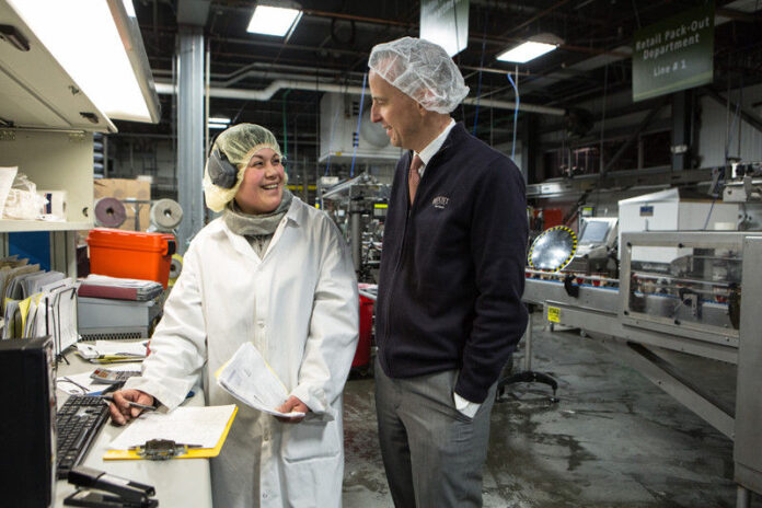 BLOUNT FINE FOODS CORP. CEO and President Todd Blount speaks with an employee at the company's Fall River facility. PBN FILE PHOTO/RUPERT WHITELEY