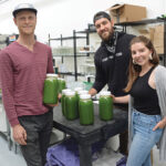 MAJOR GROWTH: From left, juicing company Fully Rooted Inc. co-owners Benjamin Aalvik, Angelo Mollis and Amanda Repose in their production space in Pawtucket. Although the retail store had to close and farmers market sales were cut in half during the COVID-19 pandemic, delivery across Rhode Island and Massachusetts grew exponentially. / PBN PHOTO/ELIZABETH GRAHAM