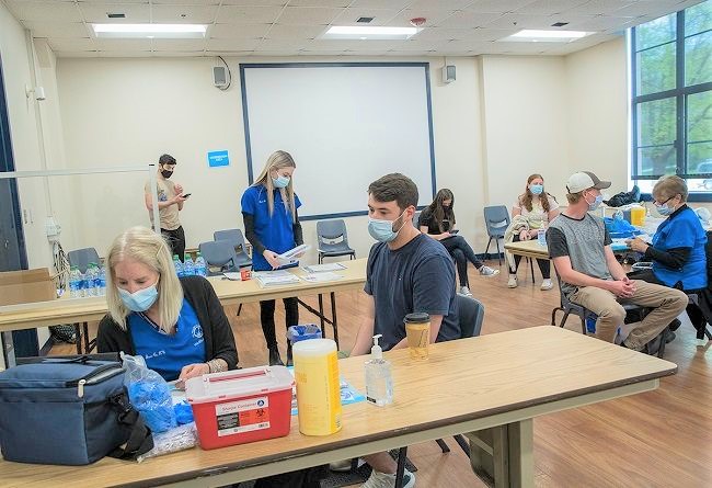 UNIVERSITY OF RHODE ISLAND students wait to be vaccinated for COVID-19 during a spring clinic in the school's Memorial Union on the Kingston campus in South Kingstown. / COURTESY UNIVERSITY OF RHODE ISLAND