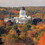 GETTING DULLER: Colorful foliage surrounds the Maine Statehouse in Augusta in 2017. Changing weather conditions have disrupted recent leaf-peeping season and could have a lasting effect on tourism in the region. / AP FILE PHOTO/ROBERT F. BUKATY  