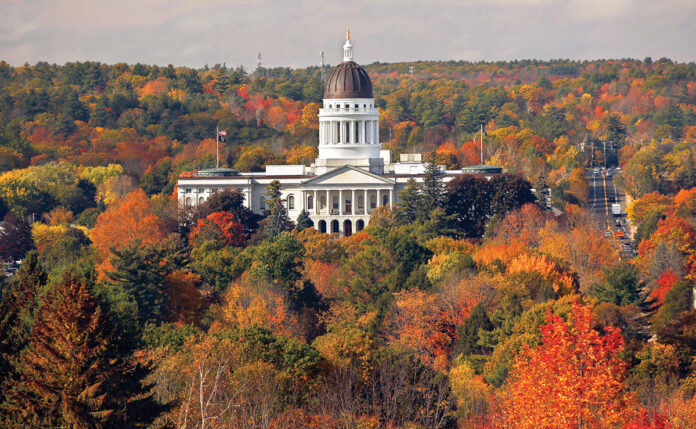 GETTING DULLER: Colorful foliage surrounds the Maine Statehouse in Augusta in 2017. Changing weather conditions have disrupted recent leaf-peeping season and could have a lasting effect on tourism in the region. / AP FILE PHOTO/ROBERT F. BUKATY  