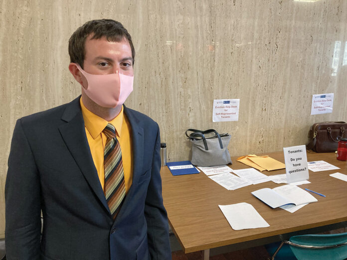 HALLWAY LAW: Troy Lange, staff attorney for the Housing Law Center at Rhode Island Legal Services, works at the Eviction Help Desk outside District Court in Providence, ready to help low-income tenants unfamiliar with the legal proceedings. / PBN PHOTO/MARC LAROCQUE