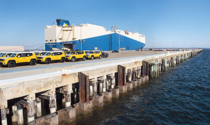 MOTOR VEHICLES ARE unloaded on Pier 1 at the Port of Davisville in North Kingstown in early 2019. Port officials say the number of imports has declined during the COVID-19 pandemic. / PBN FILE PHOTO/DAVE HANSEN