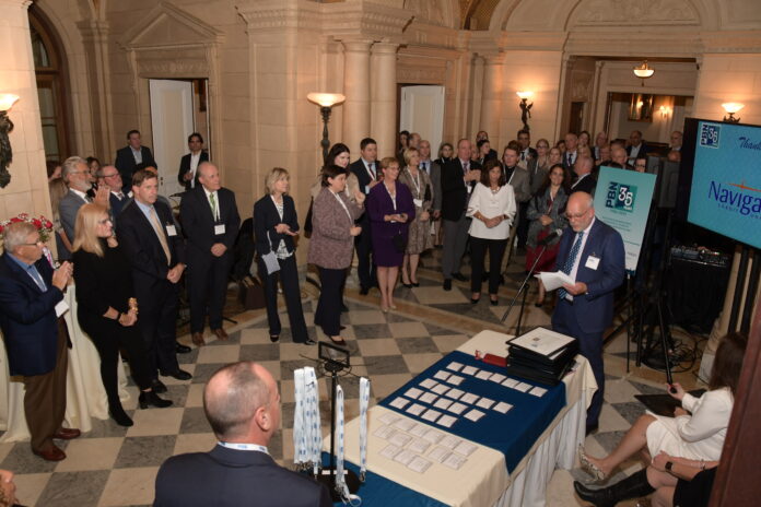 ROGER C. BERGENHEIM, far right, president and publisher of Providence Business News, delivers a speech Thursday to multiple business professionals in attendance at the news publication's 35th Anniversary Gala at Aldrich Mansion in Warwick. / PBN PHOTO/MIKE SKORSKI