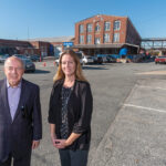 HOT PROPERTY: Michael Giuttari, left, president of Providence-based MG Commercial Real Estate Services Inc., and MG Vice President Julie Freshman outside Phillipsdale Landing in East Providence, which was listed for sale in August at $9 million.  / PBN PHOTO/MICHAEL SALERNO