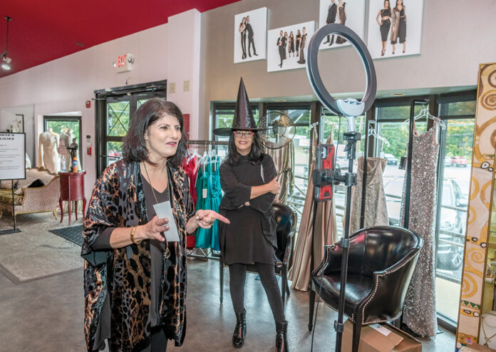 AND ... ­ACTION: Sonya Janigian, right, owner of Sonya’s Clothing, shoots a Facebook Live video in her Cranston boutique with the company’s sales manager, Carmen Garcia. / PBN PHOTO/MICHAEL SALERNO