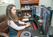 HERE TO STAY: Laura Yalanis, director of tax service for Kahn, Litwin, Renza & Co. Ltd., works in her home office in 2021. Some panelists believe remote work will become a permanent benefit offered by many local companies. PBN FILE PHOTO/MICHAEL SALERNO