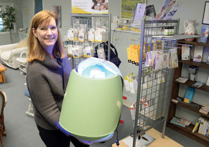 BRIGHT IDEA: Kathleen Moren, Healthy Babies, Happy Moms Inc. president, displays phototherapy equipment that allows nurses from her company to treat babies with jaundice at home rather than in a ­hospital.  PBN PHOTO/ELIZABETH GRAHAM