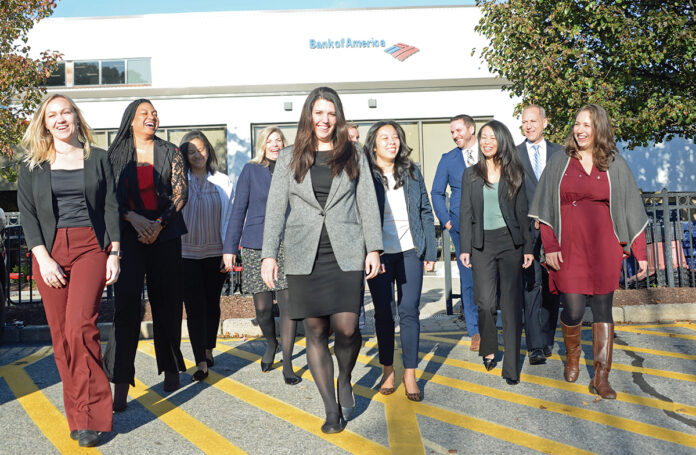 A BIG BOOST: Bank of America Corp.’s diversity recruitment efforts include hiring 10,000 people companywide from low- to moderate-income communities. Among the bank’s local diversity and inclusion leaders walking from its corporate facility in Lincoln are Kate DeTora, vice president of financial solutions, center; Phoebe E. Peck, vice president of financial solutions, far left; and Eliza Sharrah, fraud communications strategy program manager, far right. / PBN PHOTO/ELIZABETH GRAHAM