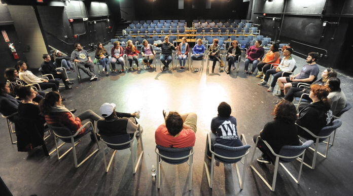 PERFORMANCE SETTING: Wheaton College students gather in a group to discuss one-minute plays inside a performing arts center at the Norton-based liberal arts college. / COURTESY WHEATON COLLEGE