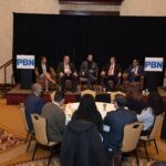 KEVIN MATTA, center of the stage, head of diversity and inclusion for Thielsch Engineering Inc., leads the discussion among panelists at Providence Business News' 2021 Diversity & Inclusion Summit and Award program at Crowne Plaza Providence-Warwick on Thursday. The other panel members are, from left, Dorca M. Paulino, diversity director for the R.I. Judiciary; Peter Rodriquez, executive director/plant manager for Amgen Rhode Island in West Greenwich; Neil D. Steinberg, CEO and president of the Rhode Island Foundation; and Lawrence E. Wilson, managing director at The Wilson Organization. PBN PHOTO/MIKE SKORSKI