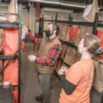 ORDER CONFIRMATION: Matthew Tortora, left, co-founder of WhatsGood, a Warwick-based online food delivery service company that sources local farmers, fishermen and artisans, checks the orders with Nickala Colglazier, aggregation specialist. / PBN PHOTO/MICHAEL SALERNO