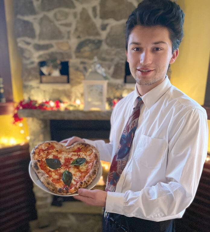 DISH IN DEMAND: Server William Fitzgerald of Imbriglio’s Pizzeria Napoletana in Newport shows off a popular item on the recent Valentine’s weekend menu. / COURTESY SARDELLA’S