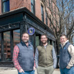 NEW DIGS: Providence Living is emerging as a real estate developer behind some of the most prominent redevelopment projects in the city. In front of their newly rehabilitated downtown headquarters at 259 Weybosset St., are, from left, Dustin Dezube, owner; Kevin Diamond, principal architect of Providence Architecture; and Eric Belisle, principal of Providence Building. / PBN PHOTO/MICHAEL SALERNO